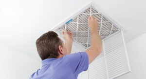 Precision Air HVAC Tech changing air filter to improve indoor air quality