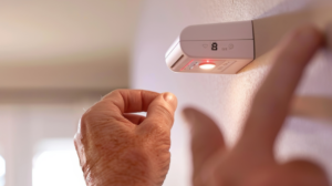 A person testing the carbon monoxide detector in their home - making sure their furnace is functioning properly