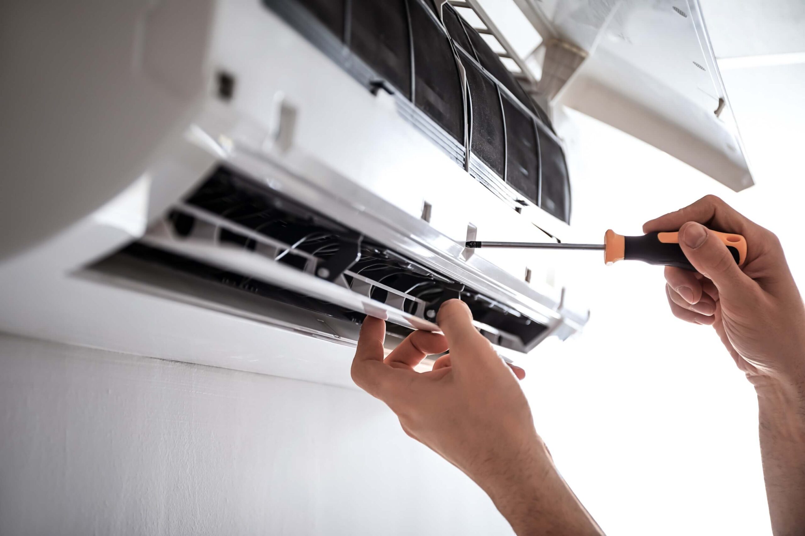 Electrician repairing air conditioning indoors